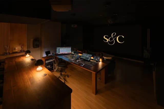An alternate Studio A view with subdued lighting at the mix position and projection screen.