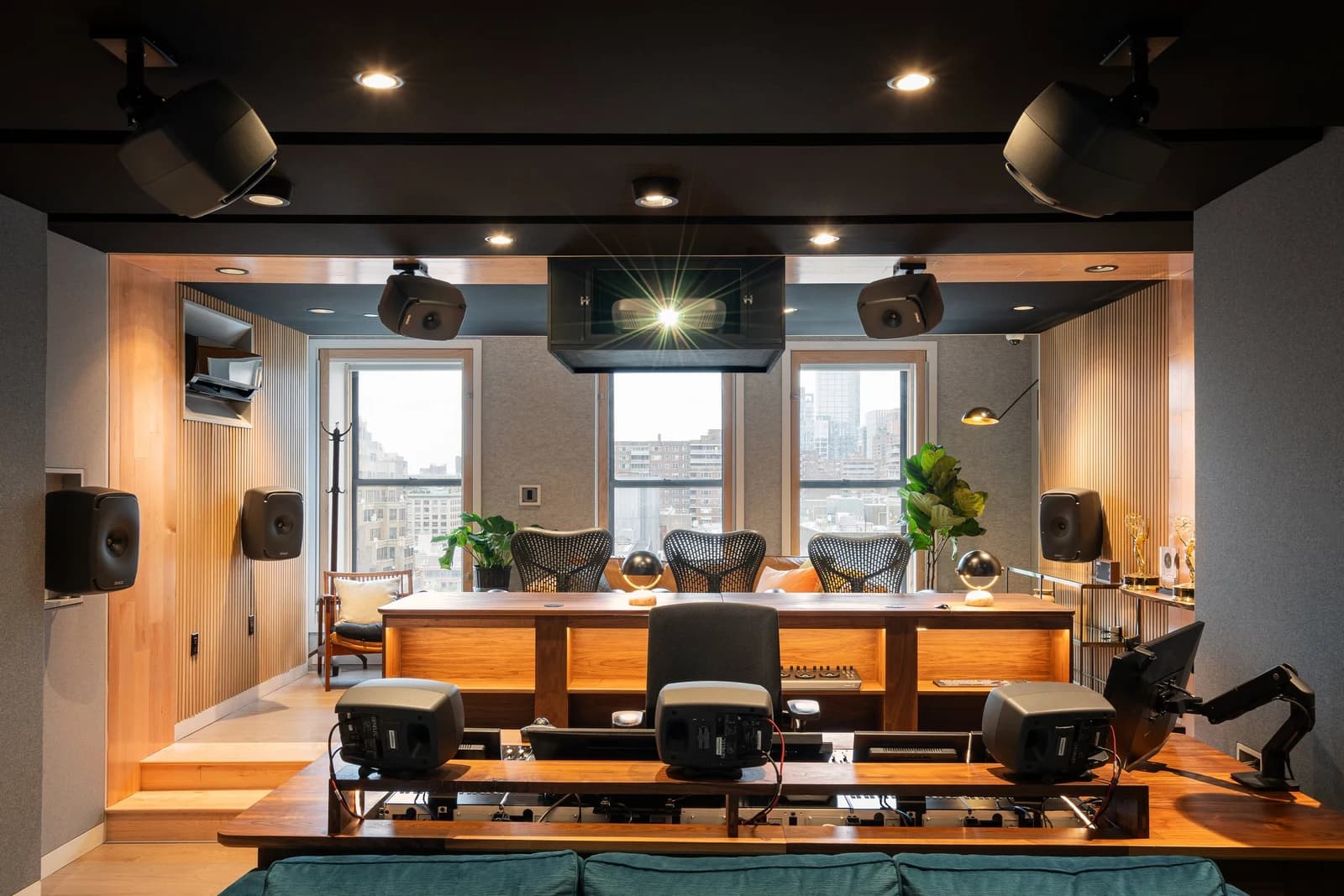 Looking toward Studio A’s rear producer seating, tiered platform and three street-facing windows.