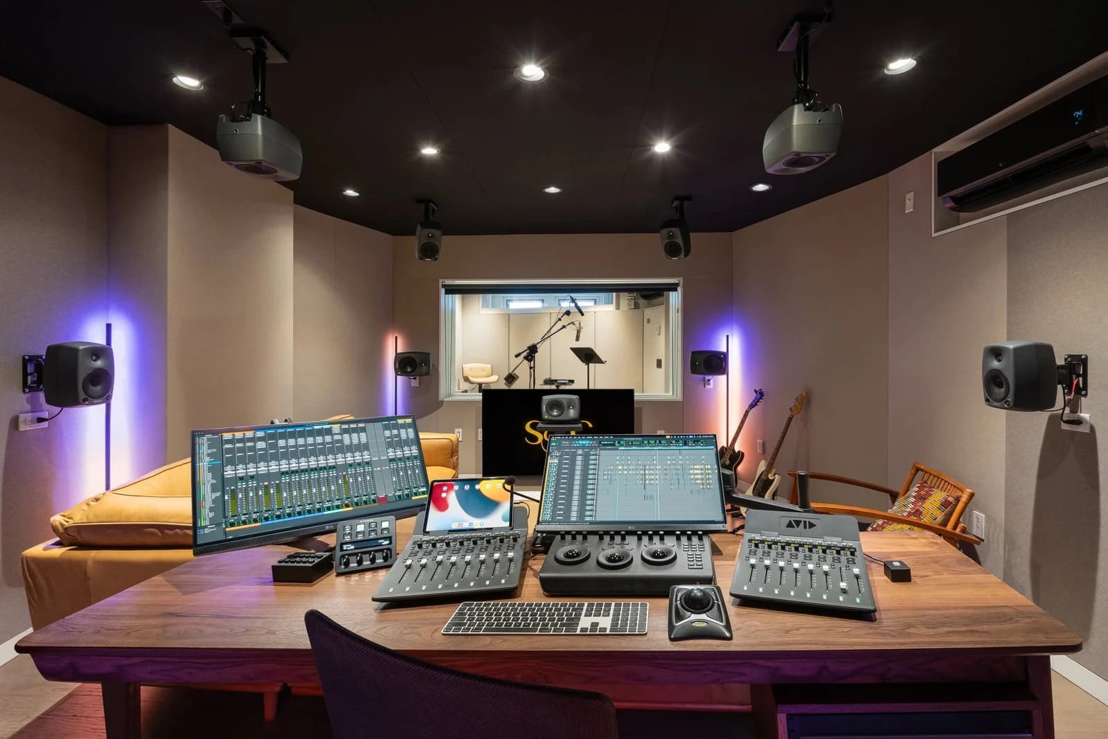Studio B from the engineer’s rear mix position, looking across client seating toward the ADR window.
