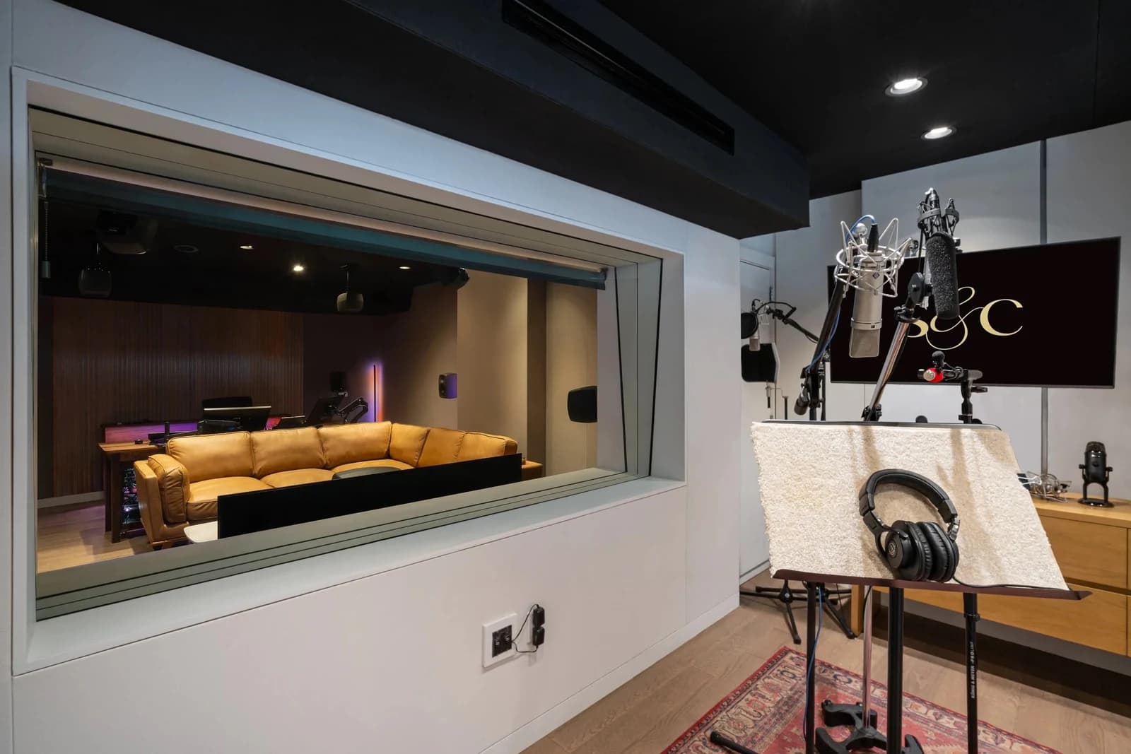 The ADR booth’s microphones and viewing window into Studio B.
